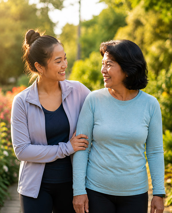 Two women walking outdoors, smiling